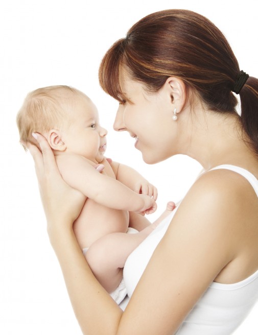 Happy mother holding newborn baby over white background